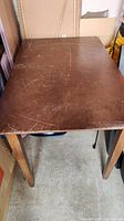 Top view of the dining table showing surface scratches and wear.