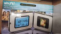 Photo of Shift3 digital photo viewer box showing the product front image with time and photo display features.