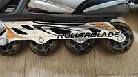 Close-up of the rollerblade wheels and frame showing condition and branding