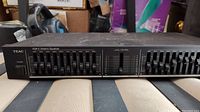 Front view of TEAC EQ-A5 graphic equalizer amplifier showing frequency sliders, level control, and power button.