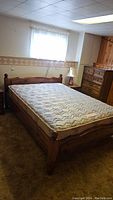 Full view of the assembled wooden bed frame with mattress in bedroom setting