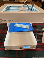 Front view of Tinkerine Ditto Pro printer showing build area with sample print