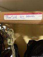 Photo showing a shelf label indicating 'MaxSold 42 costumes'