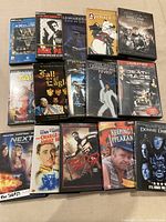 Photo showing a collection of DVDs and PC games arranged in three rows, titles visible include 'Max Payne 2', 'Death Race', 'Donnie Darko', and '300'.