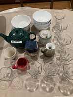 Full lot arrangement showing teapot, bowls, cups, dessert dishes, and smaller ceramic containers