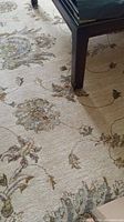 Central field under coffee table showing overall floral pattern and condition