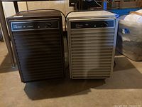 Front view of Falcon Viking 24 and Classic D25 dehumidifiers side by side on basement floor.