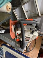 Close-up view of the front handle, motor cover with Echo branding, and chain guard.