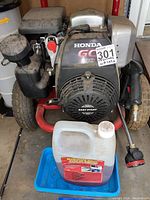 Front view of Honda GC190 pressure washer on red tubular steel frame with two pneumatic tires, plastic engine cover labeled 'Easy Start'.