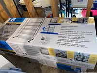 Closed box showing product specifications, features, and images of assembled shelving unit.