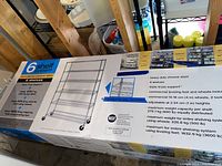 Box showing an image and specifications of the shelving unit including weight capacities and features