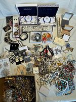 Full lot overview showing a wide selection of vintage costume jewelry including boxes, necklaces, bracelets, earrings, and pins
