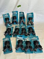 Top view of all 12 Gilmore 2-way hose shutoff valves arranged on a white fabric background.