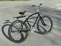 Full side view of black State Bicycle Co Klunker BMX/Cruiser Bicycle on pavement