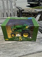 Front and window display of boxed John Deere 620LP diecast tractor model.