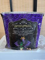Box front showing Holiday Living branding and text describing the Animated Airblown Fire and Ice Dragon product in multiple languages along with image of the dragon inflatable.