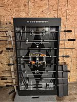 Top view of the foosball table showing the playing field, rods, and handles.