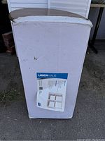 Closed white box with UberHaus label showing an image of the cube shelving unit and product details