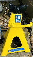 Yellow 6 ton jack stand with handle and safety labels visible on front