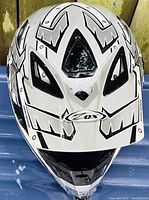 Front view of the men's motocross helmet showing the black and white angular graphic design, front ventilation, and OX branding.
