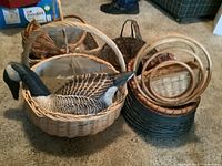 Overview of fabric duck decoy door stop inside a large wicker basket alongside several wicker baskets of different sizes and some with faux fruit inside.
