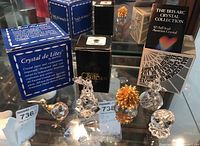 Overall lot of crystal figurines displayed together, with original boxes
