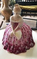 Front view of Royal Doulton Victoria HN 2471 porcelain figurine seated and holding a fan.