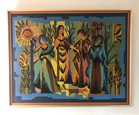 Framed needlepoint art with five stylized figures in outdoor garden-like setting.