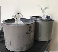 Photo of two Swarovski Silver Crystal figurines (bee and dragonfly) on original boxes.