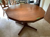 Front view of the solid oak octagonal pedestal dining table showing the tabletop shape and wood grain.
