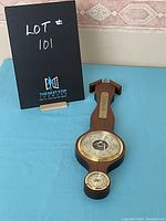 Full display of the vintage wooden barometer, showing the entire item including the thermometer and hygrometer dials.