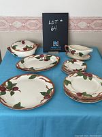 Full view of the Franciscan dish set arranged on a blue cloth with all pieces visible including gravy boat, covered dish, plates, and platter.
