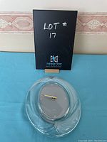 Full view of the Mikasa glass clock showing the entire glass body with the oval clock face in the center.