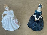 Front view of Cherie and Amanda Royal Doulton figurines highlighting dresses and postures