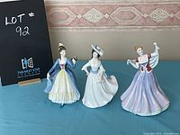 Front view of all three Royal Doulton ladies figurines: June, Margaret, and Leading Lady