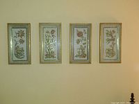 Full set of four floral cherub plaques showing all four seasons with gold trimmed frames.