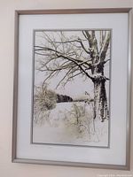 Full view of framed black and white photograph showing snow-covered tree and landscape, signed by Neal Parent.
