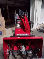 Front view showing red steel auger housing with HSS928A decal and intake auger