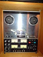 Front view of TEAC 3340S reel-to-reel tape deck in wooden cabinet