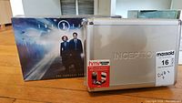 Inception Dream Machine metal case in front, The X-Files complete series box behind