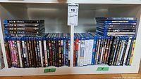 Two shelves of Blu-ray discs arranged under a lot tag
