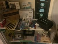 Shelf displaying various kits and components including UNO R3, LCD display, Pi starter kits, oscilloscope case and tool pouches