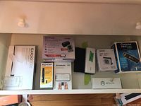 Top view showing all health monitoring devices in original boxes arranged side by side including QardioCORE, Kanox blood pressure monitor, Accu-Chek test strips, Kardia Mobile, and Omron blood pressure monitors.