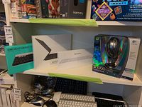 Overview of four unopened boxes: Logitech K780, Apple Smart Keyboard Folio, Logitech MX1000 mouse, Apple Magic Keyboard