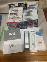 Overview of game cases stacked with manuals and accessories in front