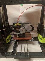 Front view of printer frame and heated bed with extruder assembly visible