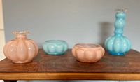 Front angled view showing all four melon-shaped glass pieces: two peach and two blue with crimped rims.