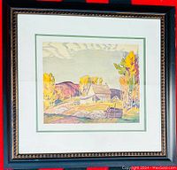 Frontal photo of the framed print showing the entire piece with frame, depicting the autumn cabin landscape