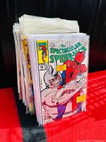 Stack of vintage Marvel Spectacular Spider-Man comics bagged and boarded with clear protective covers.