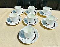 Photo showing all six cups placed on their matching saucers, displaying the set quantity and design consistency.
